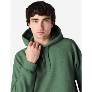 A green hooded sweatshirt with a large hood, featuring a logo, worn by a male model.