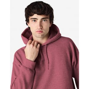 A maroon hooded sweatshirt is worn by a model with a hood pulled back, featuring a subtle brand logo.