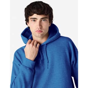 A blue Gildan Heavy Blend adult hooded sweatshirt with a drawstring hood and a model adjusting the neckline.