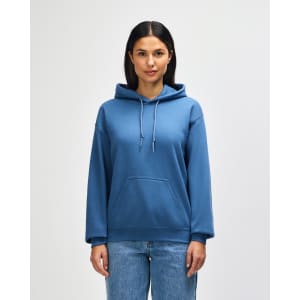 A blue Gildan Heavy Blend adult hooded sweatshirt on a model, featuring a front pocket and a drawstring hood.