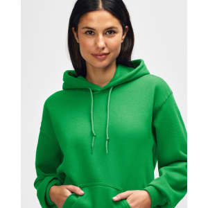 A green hooded sweatshirt featuring a woman with long hair, wearing the hood and posing. The sweatshirt has a logo.