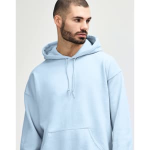 A blue hooded sweatshirt with a front pocket, worn by a young woman with long hair. It features a logo on the garment.