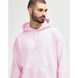 A model wearing a pink Gildan Heavy Blend Adult Hooded Sweatshirt with the hood up.