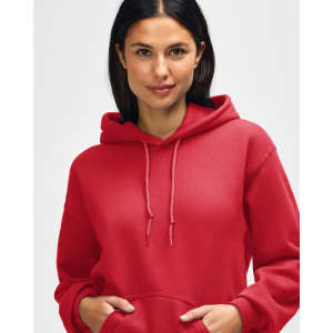 A red Gildan Heavy Blend adult hooded sweatshirt worn by a model, featuring a hood and drawstrings.