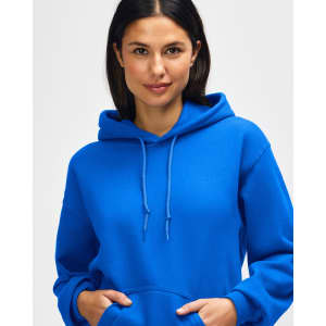 A blue hooded sweatshirt is worn by a model, featuring a drawstring and a branding logo.