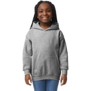 A grey youth hooded sweatshirt with a front pocket, modelled by a smiling girl. It features a logo on the front.