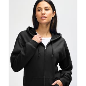 A black full zip hooded sweatshirt worn by a young man, featuring a logo on the front.