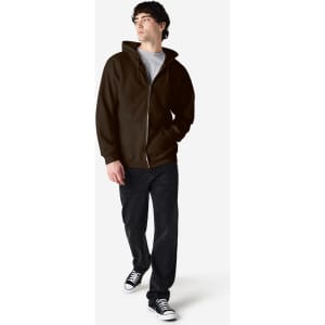 A model wears a brown Gildan Heavy Blend full zip hooded sweatshirt with a grey t-shirt and black pants.