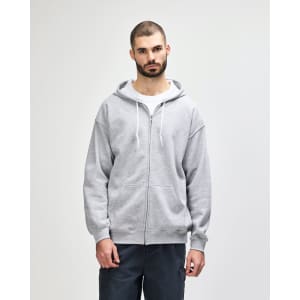 A grey full zip hooded sweatshirt worn by a man, featuring a front zipper and drawstring hood. It has a logo.