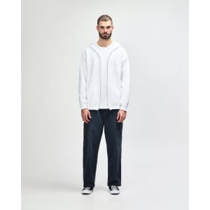 A white Gildan Heavy Blend full zip hooded sweatshirt worn with black pants and sneakers, featuring a front pouch pocket.