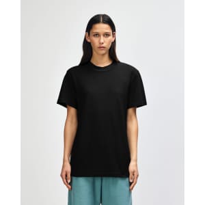 A black unisex pique mockneck T-shirt displayed on a model, featuring a logo on the garment.