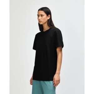 A black unisex pique mockneck T-shirt displayed on a model, featuring short sleeves and a slight mock neckline.