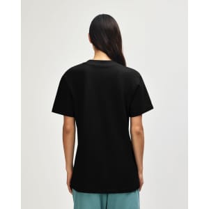 A black unisex pique mockneck t-shirt featuring a simple design and a logo on the back.
