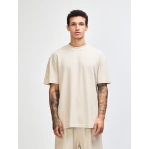 Unisex mockneck T-shirt in a neutral beige colour, featuring a relaxed fit and logo detail.