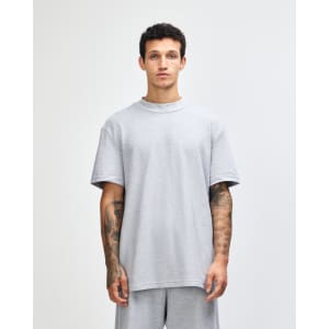A grey unisex pique mockneck t-shirt with short sleeves and a logo.