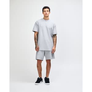 A grey unisex pique mockneck T-shirt with short sleeves and a standard fit. It features a logo on the garment.