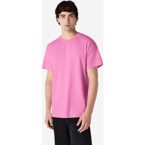 A pink Gildan Ultra Cotton adult t-shirt displayed on a model, featuring short sleeves and a basic cut.