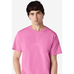A pink Gildan Ultra Cotton adult T-shirt displayed by a model, featuring a plain design and a logo.