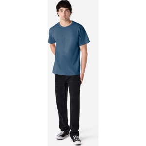 A model wearing a blue Gildan Ultra Cotton adult T-shirt paired with black pants and sneakers.