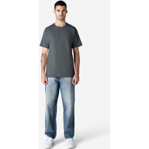 A grey Gildan Ultra Cotton adult T-shirt displayed on a male model, paired with light blue jeans and white shoes.