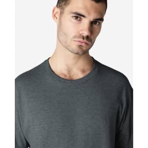 A grey Gildan Ultra Cotton adult t-shirt displayed on a male model, featuring a round neckline and long sleeves.