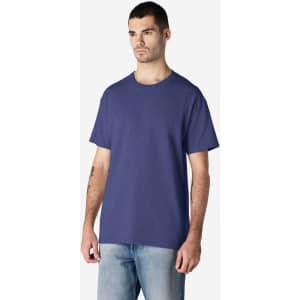 A navy Gildan Ultra Cotton adult t-shirt on a model, featuring a simple design and a logo.
