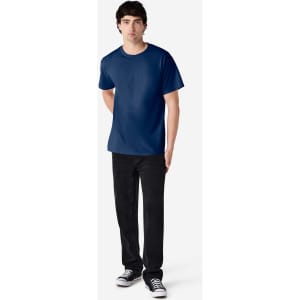 A navy Gildan Ultra Cotton adult t-shirt displayed on a model, paired with black trousers and sneakers.