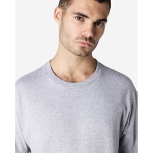 A grey Gildan Ultra Cotton adult t-shirt displayed on a model, featuring long sleeves and a round neckline.