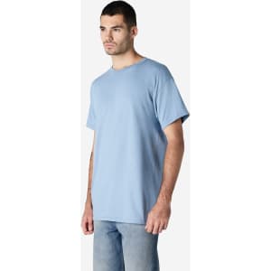 A blue Gildan Ultra Cotton adult t-shirt worn by a person, featuring a simple design and a logo.