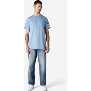 A light blue Gildan Ultra Cotton adult t-shirt on a model, paired with faded jeans and white shoes.