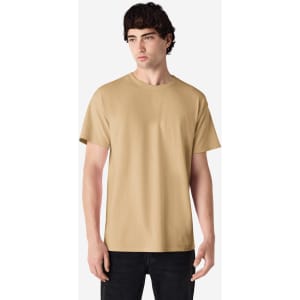 A light brown adult t-shirt displayed on a model, featuring short sleeves and a round neck. It includes a logo.