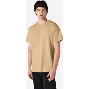 A man wearing a plain khaki Gildan Ultra Cotton adult T-shirt, standing against a white background.