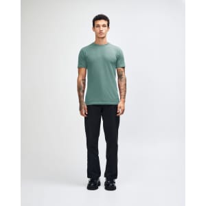 A unisex fine jersey short sleeve t-shirt in teal, paired with beige cargo pants, worn by a model.