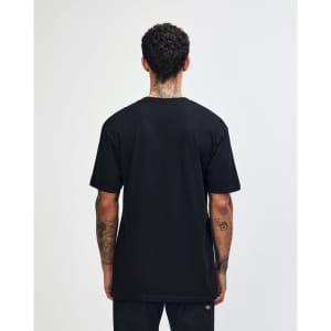 A person wearing a black unisex short sleeve t-shirt, viewed from the back, with a slight curl in the hair.