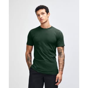 A dark green unisex fine jersey short sleeve T-shirt displayed on a model, featuring a branding logo.