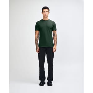 A green unisex fine jersey short sleeve T-shirt paired with blue denim jeans, worn by a model.