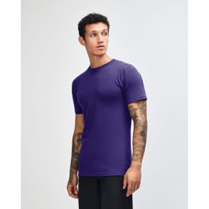 A purple unisex short sleeve T-shirt displayed on a model, featuring a logo on the chest.