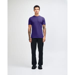 A unisex fine jersey short sleeve T-shirt in purple, worn with beige cargo pants, featuring a logo.
