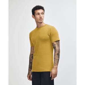 A unisex short sleeve T-shirt in mustard yellow, featuring a simple design and a logo.