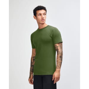 A model wearing an olive green unisex fine jersey short sleeve t-shirt, posed in profile.