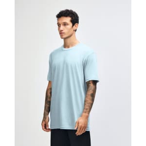 A unisex fine jersey short sleeve t-shirt in light blue, displayed on a model from a side angle.