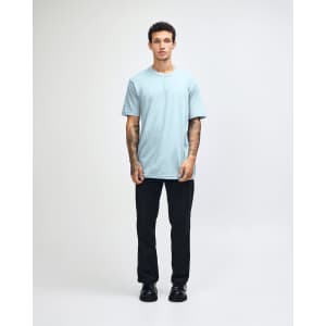 A light blue unisex short sleeve T-shirt with a crew neck and a simple design, featuring a logo.