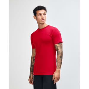 A red unisex short sleeve t-shirt displayed on a model from the side, featuring a branding logo.