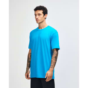 A unisex fine jersey short sleeve t-shirt in bright blue, displayed on a model from the side. It features a logo.