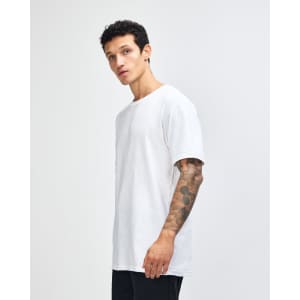 A white unisex fine jersey short sleeve t-shirt displayed on a model from the side. The shirt has a logo.