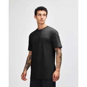 A black unisex CVC short sleeve t-shirt displayed on a model, featuring a simple design and a logo.