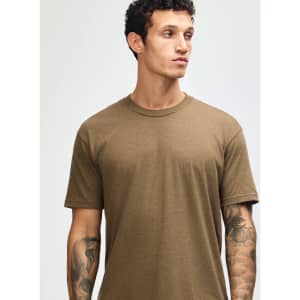 A unisex short sleeve t-shirt in a muted brown colour, displayed on a model. Features a logo.