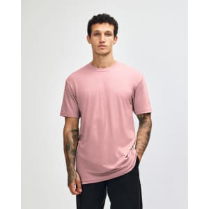 A unisex CVC short sleeve t-shirt in a soft pink colour, featuring a simple design and a logo.