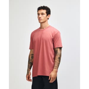 A unisex short sleeve T-shirt in a muted terracotta colour, featuring a minimalist design and a logo.