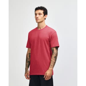 A unisex CVC short sleeve T-shirt in a rich red colour, displayed on a model in profile. It has a logo.